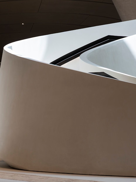 Curved architectural detail of Zayed National Museum exterior in Abu Dhabi.