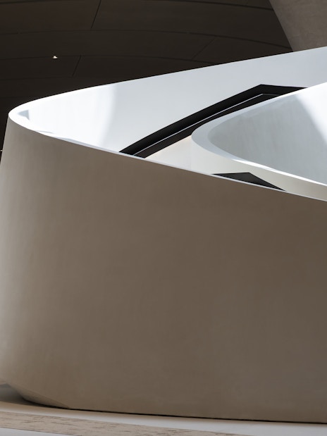 Curved architectural detail of Zayed National Museum exterior in Abu Dhabi.