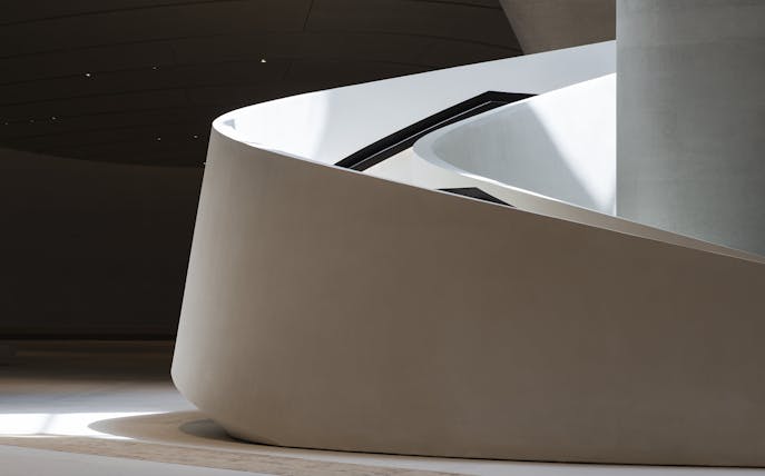 Curved architectural detail of Zayed National Museum exterior in Abu Dhabi.