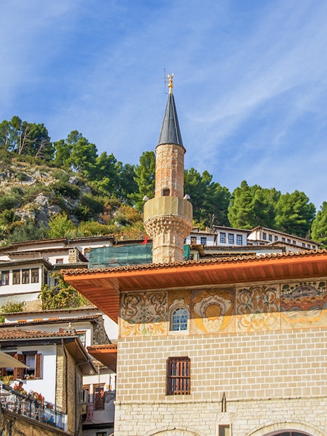 Old Bachelors' Mosque in Berat with hillside and traditional houses.