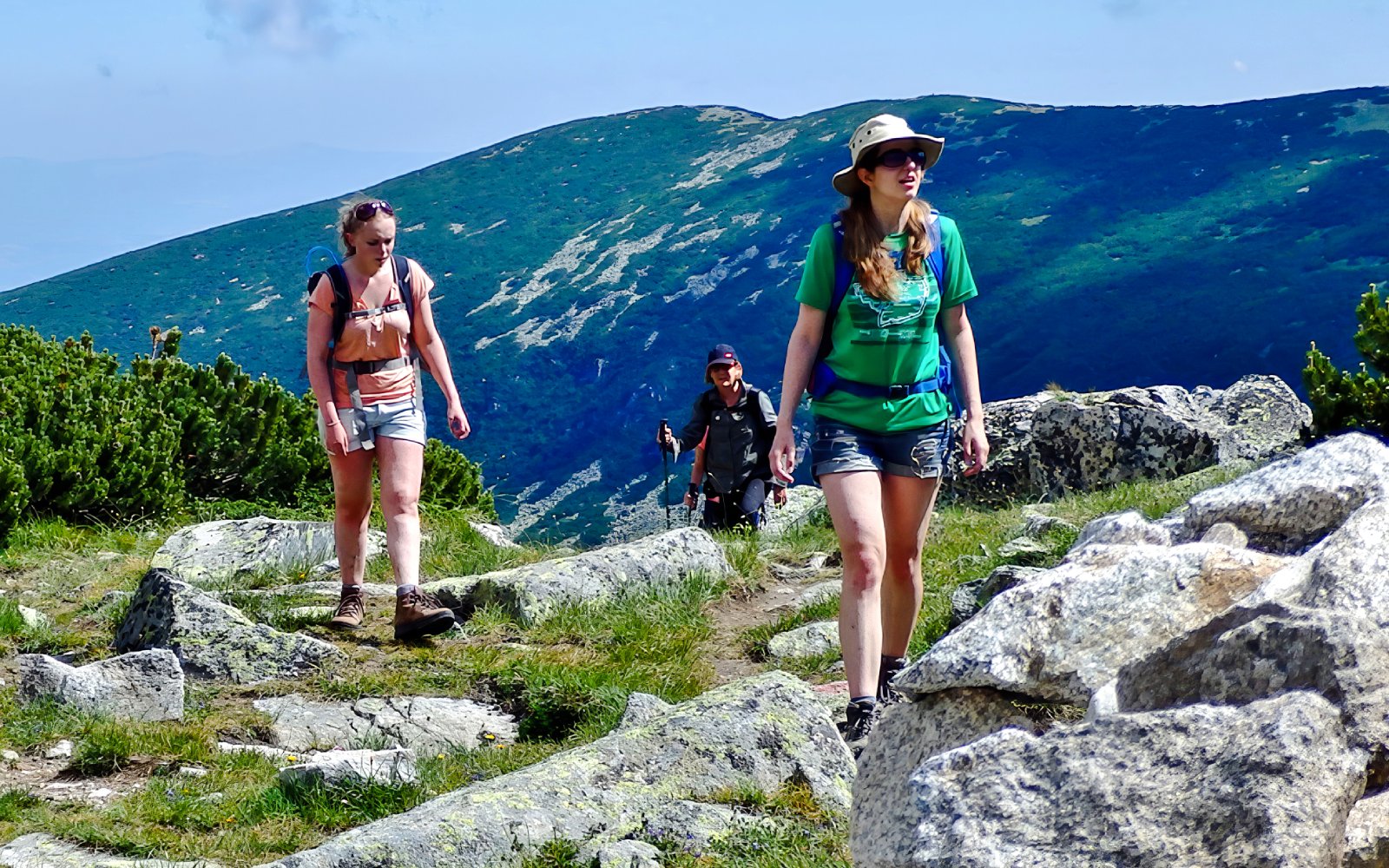 Hikers on a trail with mountain views during The Seven Rila Lakes tour from Sofia.