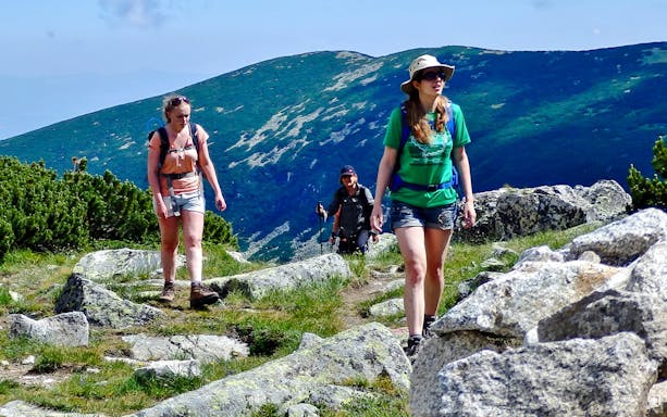 Hikers on a trail with mountain views during The Seven Rila Lakes tour from Sofia.
