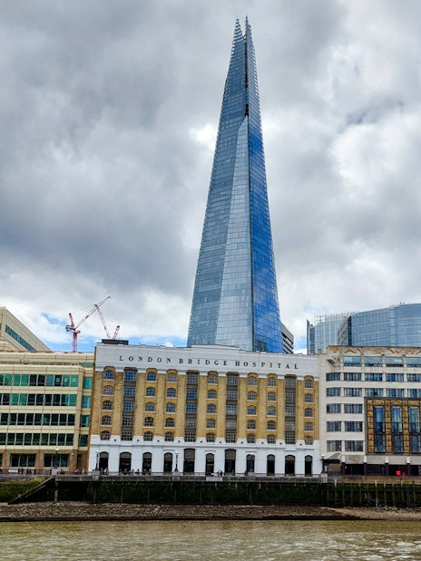 The Shard and London Bridge Hospital viewed from the Thames on a sightseeing cruise.