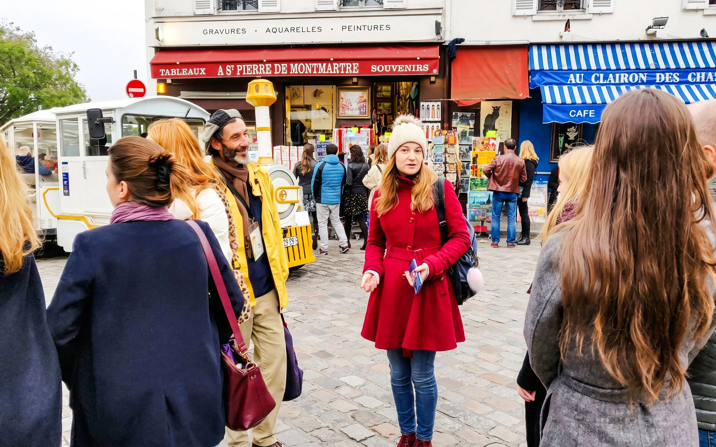 Tour group exploring Montmartre street art with a local artist guide in Paris.