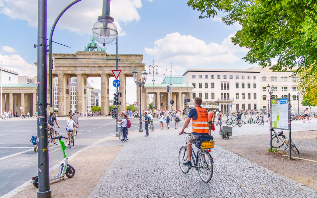 Cyclists near Brandenburg Gate on Berlin Wall bike tour.