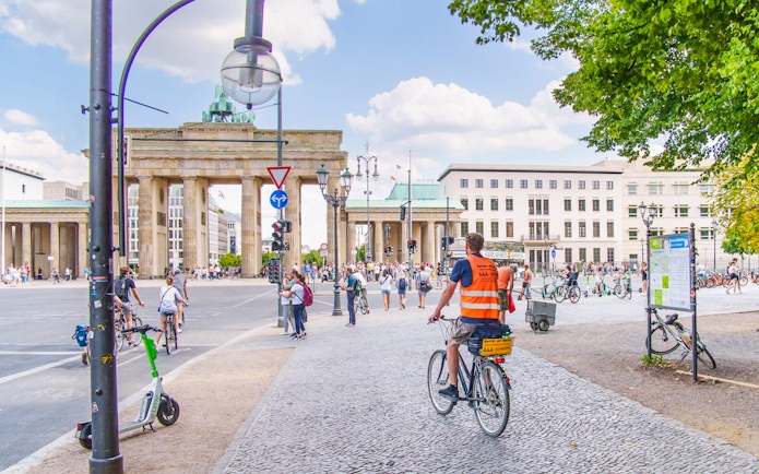 Cyclists near Brandenburg Gate on Berlin Wall bike tour.