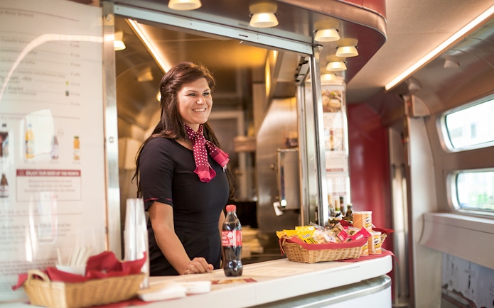 Train attendant serving snacks and drinks on Interrail Germany Mobile Pass Flex - 2nd Class.