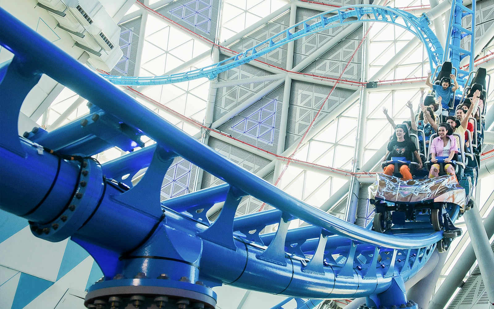 Riders on The Storm Coaster in Dubai, experiencing a thrilling indoor roller coaster.