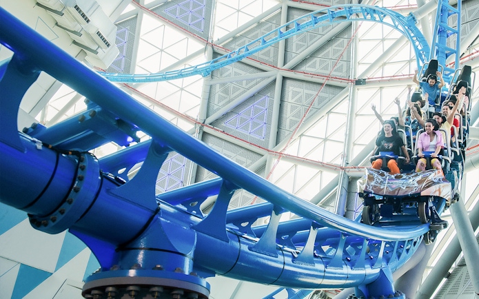 Riders on The Storm Coaster in Dubai, experiencing a thrilling indoor roller coaster.