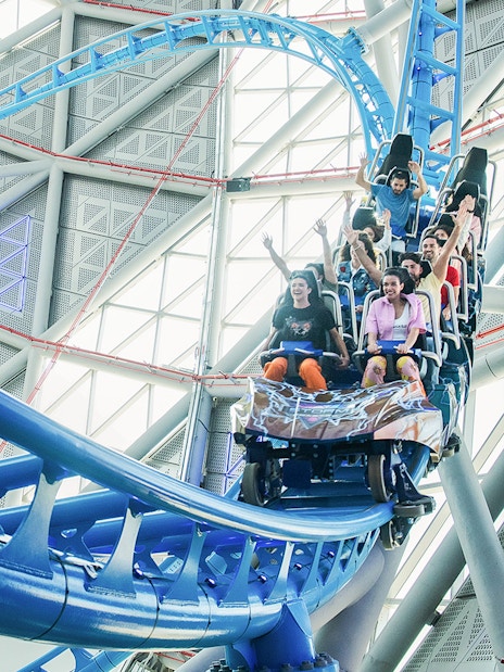Riders on The Storm Coaster in Dubai, experiencing a thrilling indoor roller coaster.