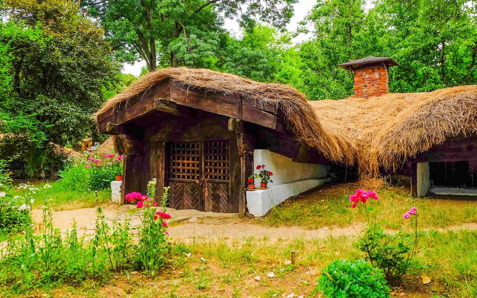 Traditional thatched-roof house at Dimitrie Gusti National Village Museum, Bucharest.