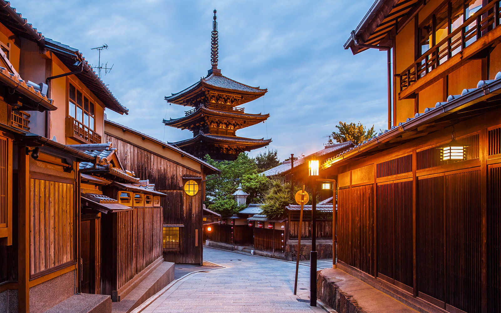 Japanese pagoda in Kyoto at twilight with traditional wooden buildings.