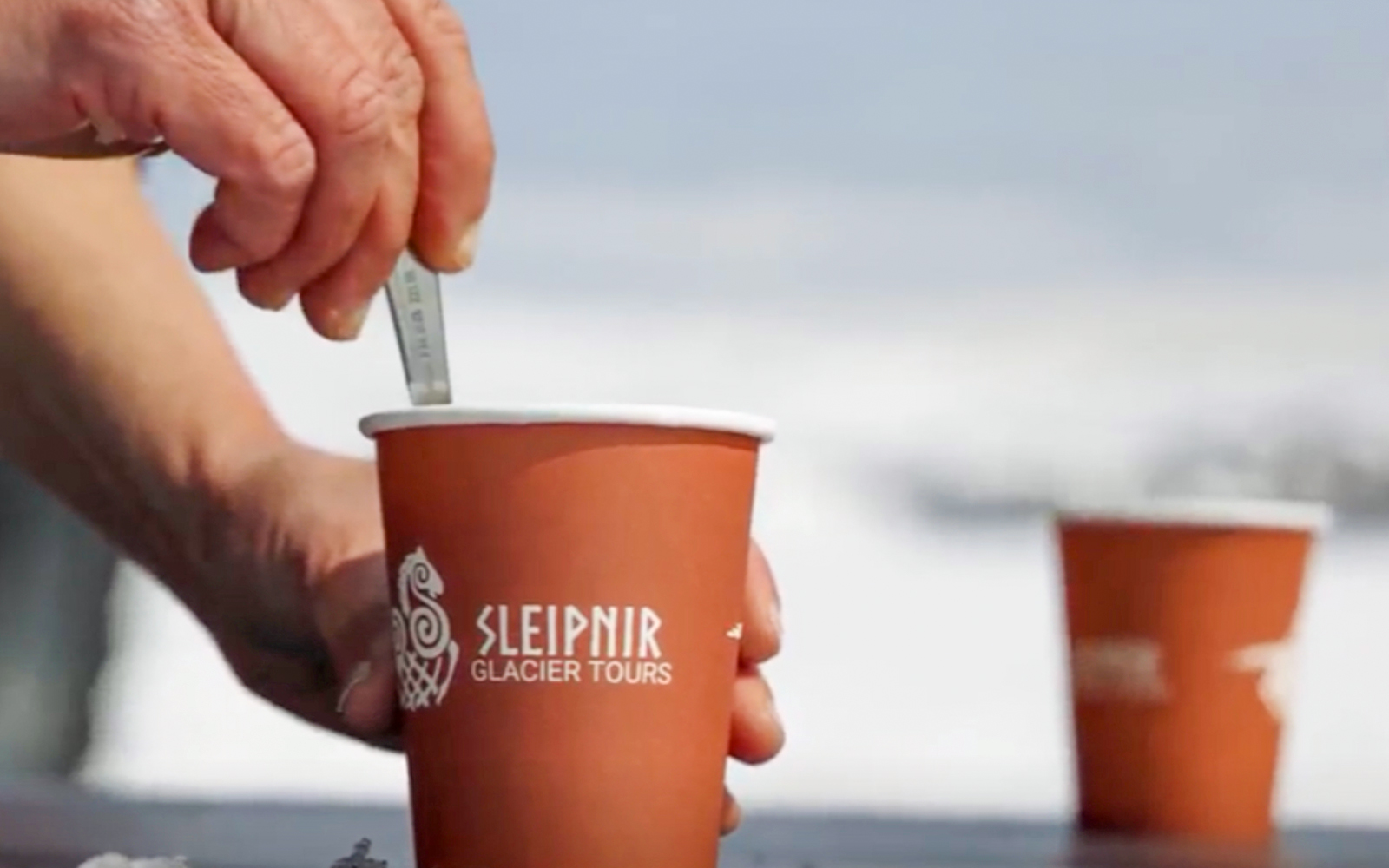 Coffee cup with Sleipnir Glacier Tours logo during Red Glacier Monster Truck Tour.