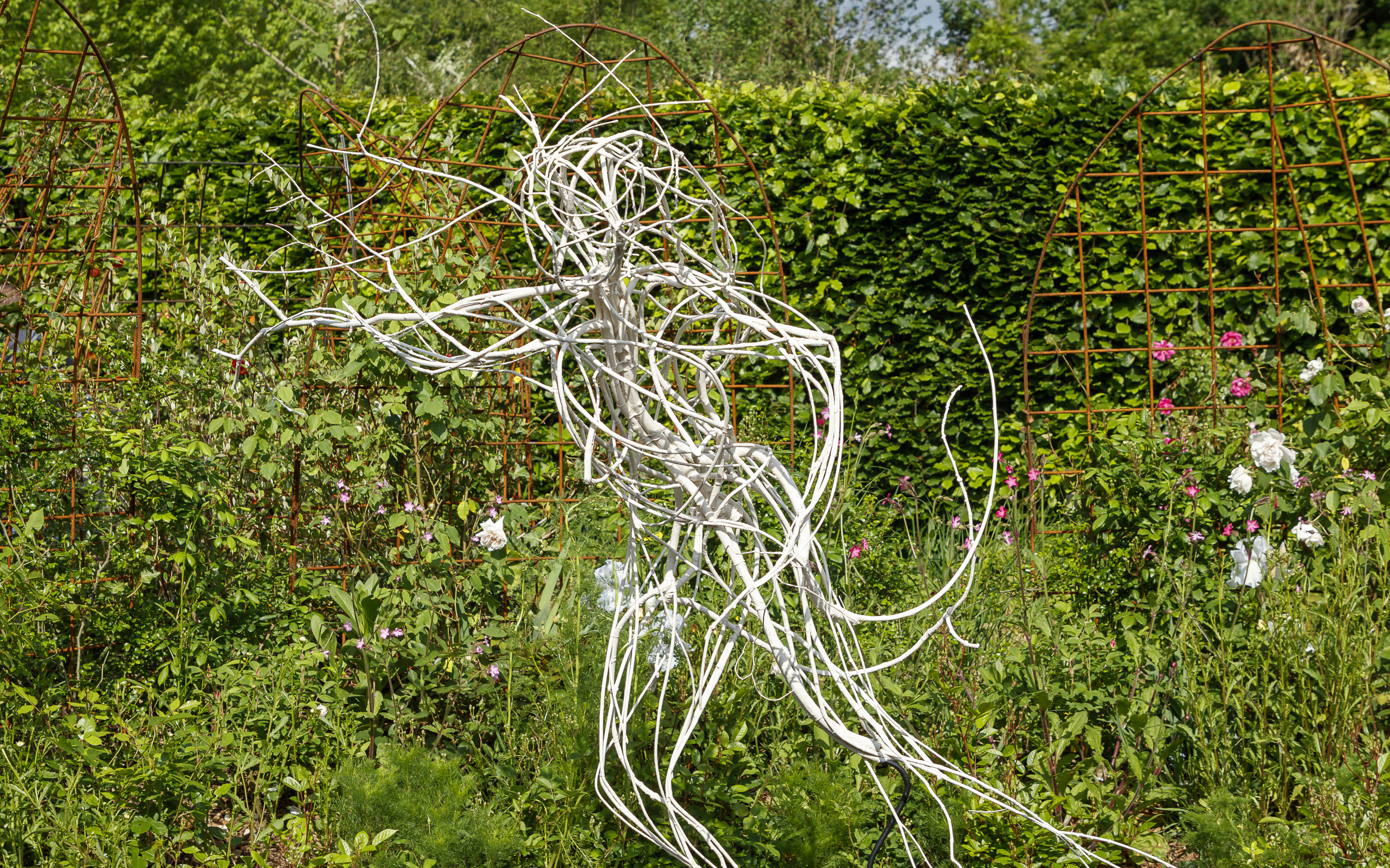 Sculpture in the gardens of Chaumont-sur-Loire Castle, surrounded by lush greenery.