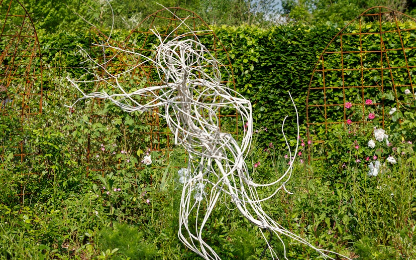 Sculpture in the gardens of Chaumont-sur-Loire Castle, surrounded by lush greenery.