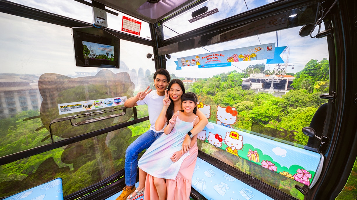 Tourists on Singapore Cable Car with city view, visiting S.E.A Aquarium.