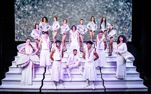 Cabaret performers in white costumes on stage in Paris for "My First Cabaret" show.