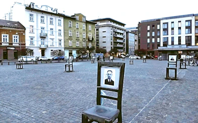 Empty chairs memorial at Heroes Square, Krakow, symbolizing Holocaust victims.