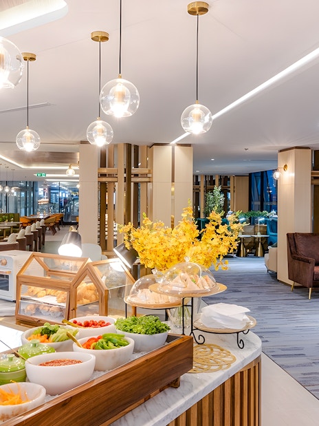Buffet and seating area at Coral Cosmo Lounge, Concourse C, Bangkok airport, Thailand.