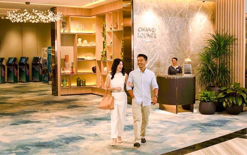 Couple walking in Changi Lounge at Jewel Changi Airport.