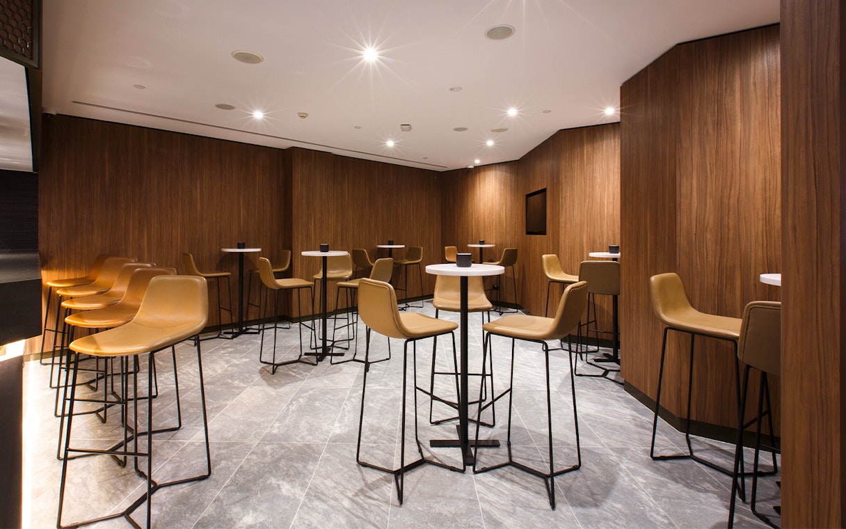 Plaza Premium Lounge seating area with modern chairs and tables.