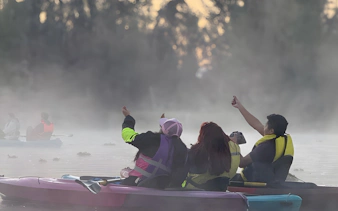 Kayakers at sunrise in Xochimilco canals, Mexico, enjoying the misty morning.