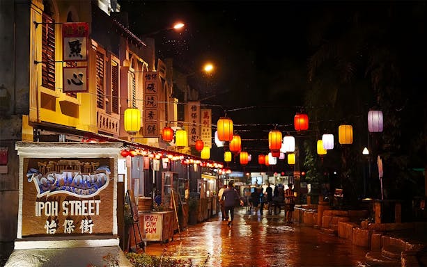 Lost World of Tambun Ipoh Street at night with colorful lanterns and visitors strolling.