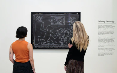 Visitors viewing Keith Haring's Subway Drawings at Moco Museum, London.