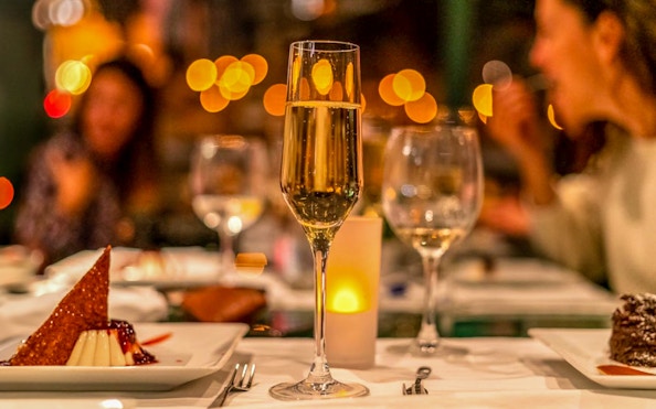 Champagne and dessert on a table during Budapest dinner cruise.