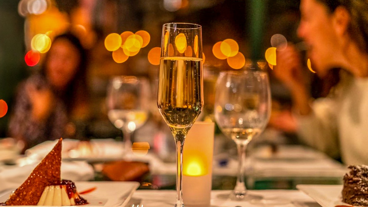 Candlelit dinner on Budapest cruise with live music and city skyline views.
