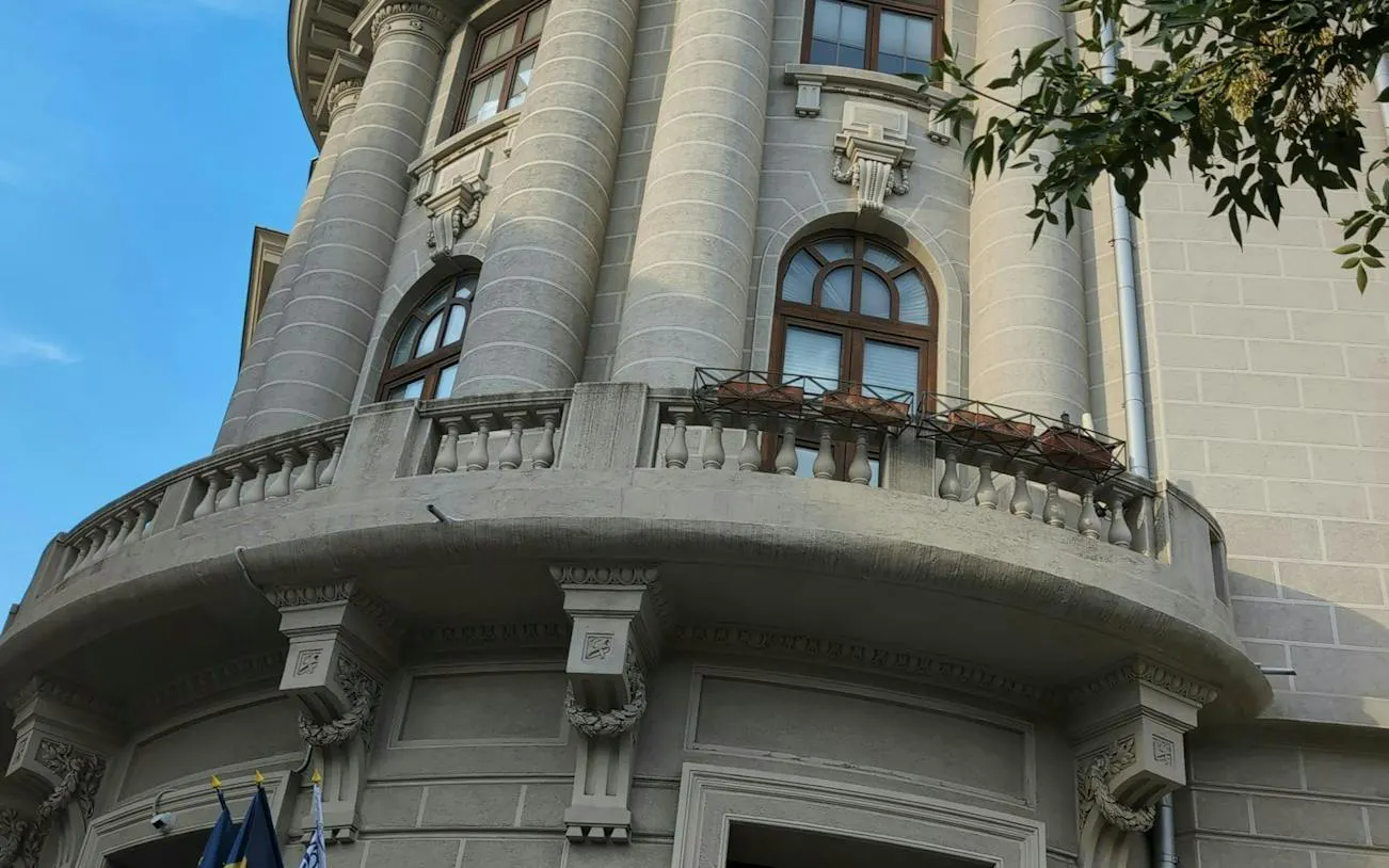 Historic building facade with arched windows in Bucharest, part of the self-guided city exploration game.
