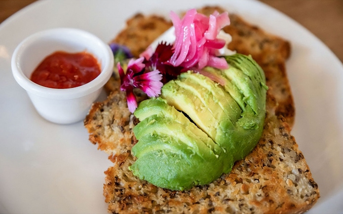 Avocado toast with pickled onions and flowers, served with a side of salsa on the Mary Valley Rattler Train.