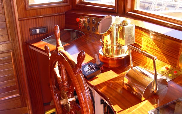 Wooden ship helm and brass controls on Elaphite Islands cruise.