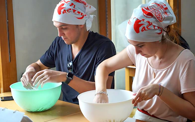 Participants making ramen at a cooking class in Ramen Factory Kyoto.
