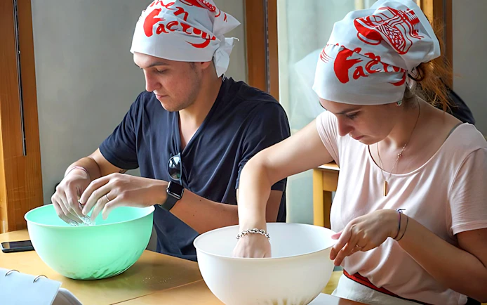 Participants making ramen at a cooking class in Ramen Factory Kyoto.
