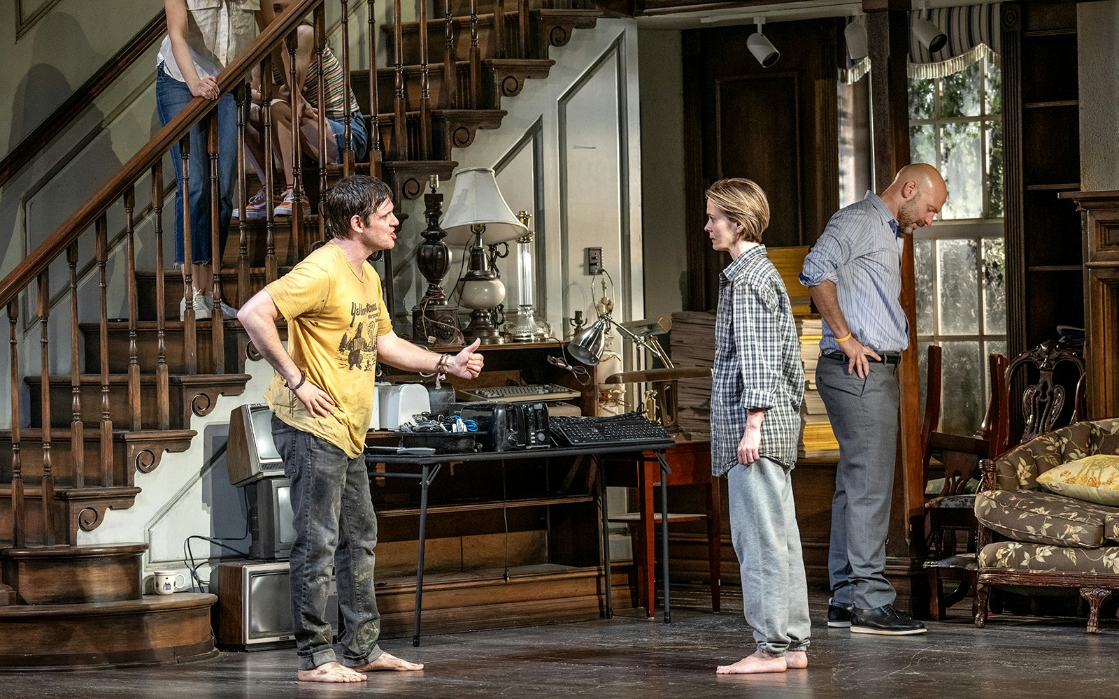 Indoor theater scene with actors in a dramatic confrontation, set in a vintage living room.