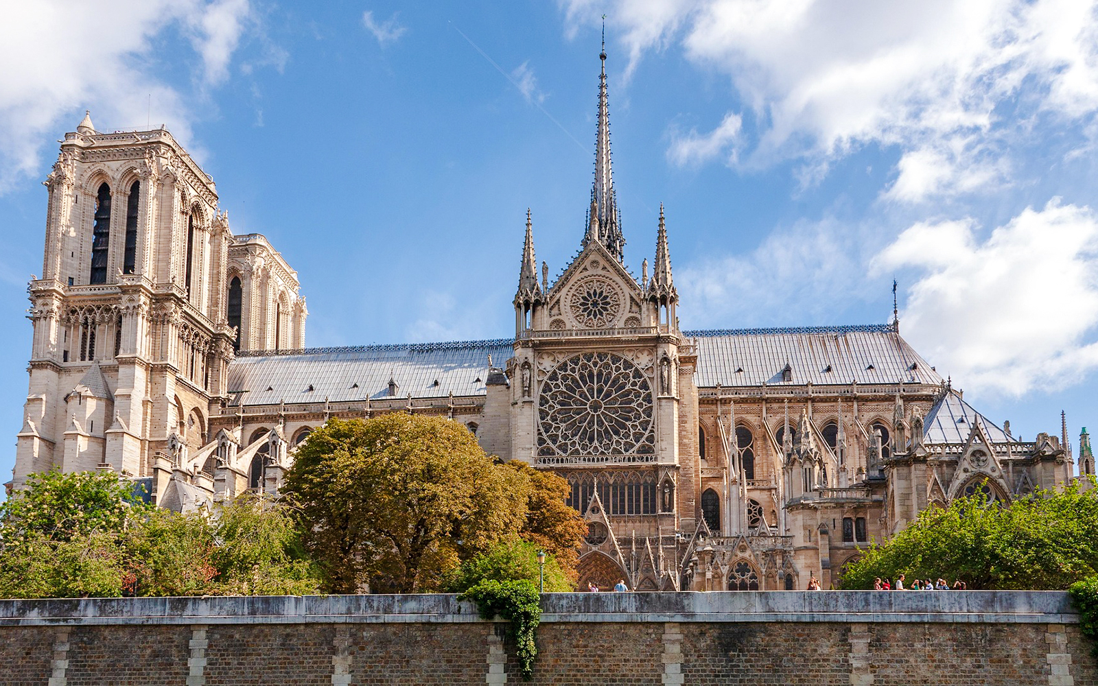 Notre Dame Cathedral exterior with spire and rose window, Paris.