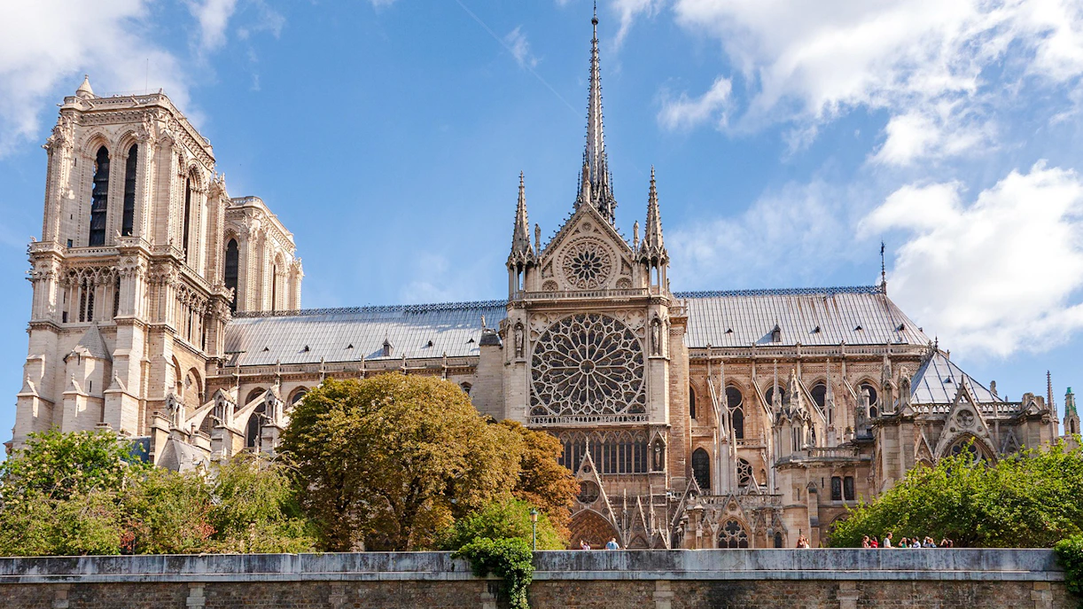 Notre Dame Cathedral exterior with spire and rose window, Paris.