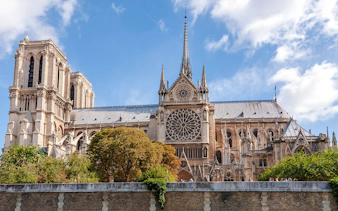 Notre Dame Cathedral exterior with spire and rose window, Paris.