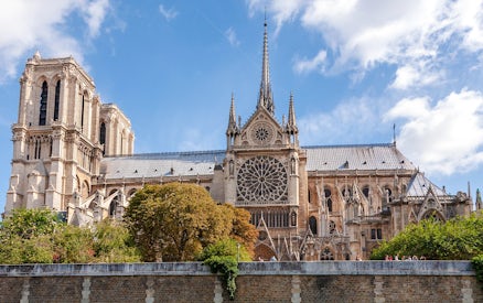 Notre Dame Cathedral exterior with spire and rose window, Paris.