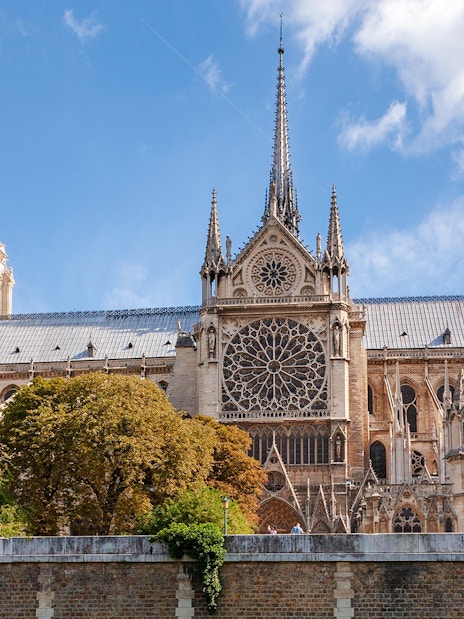 Notre Dame Cathedral exterior with spire and rose window, Paris.