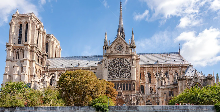 Notre Dame Cathedral exterior with spire and rose window, Paris.