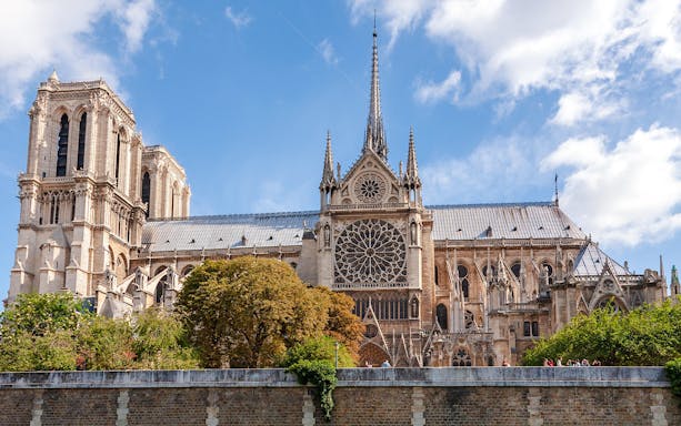 Notre Dame Cathedral exterior with spire and rose window, Paris.