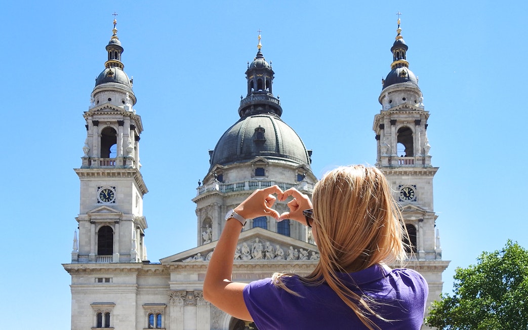 Tourist photographing St. Stephen's Basilica in Budapest.
