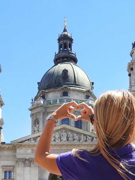 Tourist photographing St. Stephen's Basilica in Budapest.
