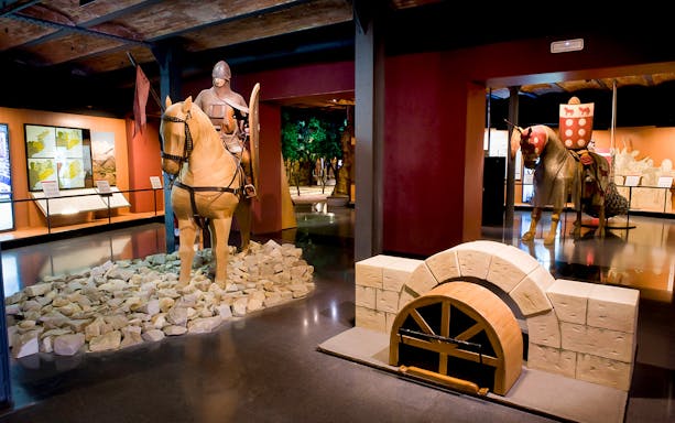 Medieval knight on horseback display in History Museum exhibit.