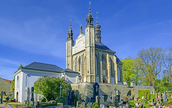 Kutna Hora church with cemetery on a sunny day during half-day tour.