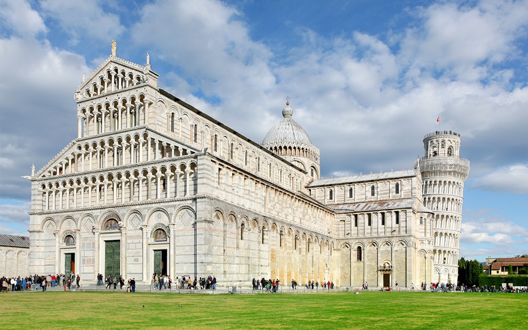 Pisa Cathedral facade with tourists, part of Pisa Monumental Complex, Italy.