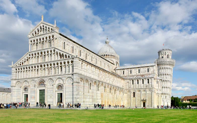 Pisa Cathedral facade with tourists, part of Pisa Monumental Complex, Italy.