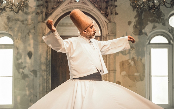 Whirling Dervish performing in Istanbul during Mevlevi Sema ceremony.